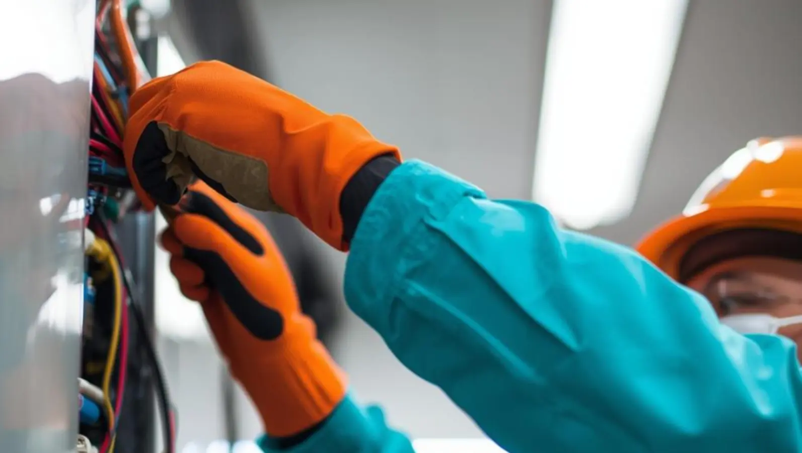 Electrician working on electrical panel